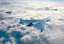 Giant Stealth Wings Emerge In China Three drones flying above the clouds in a clear sky