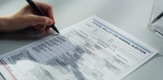 A person filling out an official ballot for a general election