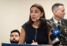 Fox Host’s Jab Ignites AOC Firestorm A woman speaking passionately at a podium with a microphone
