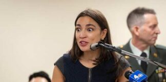 A woman speaking passionately at a podium with a microphone