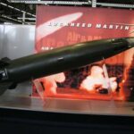 A missile model displayed at a trade show with Lockheed Martin branding