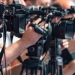 NASCAR Star Kyle Busch’s Mysterious Death Stuns Fans television cameras on tripods at a media event
