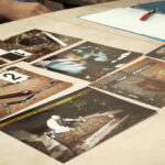 Collection of photographs laid out on a table for analysis