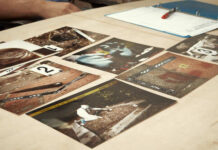 Collection of photographs laid out on a table for analysis