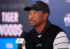 Tiger Tease, His He Making A Comeback? Man speaking at a press conference wearing black cap