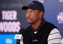 Tiger Tease, His He Making A Comeback? Man speaking at a press conference wearing black cap