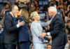 GOP Overreach Warning – From A Red-State Governor People exchanging greetings at a public event.