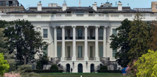 The White House with tourists in the foreground.