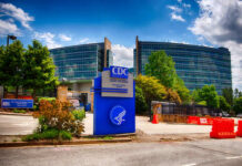 Fauci Drops Bombshells Signage of the CDC headquarters with modern buildings in the background