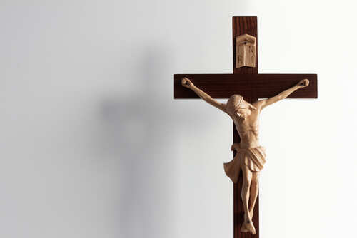 Crucifix,Cross,Against,White,Background Wooden crucifix with a figure of Jesus Christ