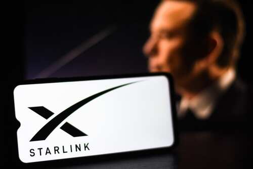 Focus,On,The,Starlink,Logo,On,A,Mobile,Screen,Stock A smartphone displaying the Starlink logo with a blurred figure in the background