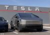 Tesla Cybertruck parked in front of a Tesla building