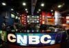 Whoopi’s Vote Warning Sparks Firestorm Interior of a CNBC news studio with multiple screens and a modern design