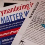 Close-up of election materials including a ballot and informational flyers